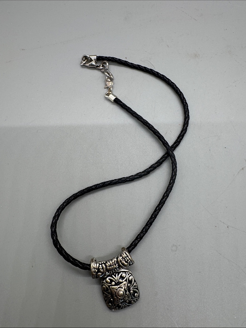 Black Braided Cord Necklace with Decorative Silver-Tone Pendant